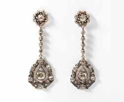200 42 A pair of 14 carat white gold and diamond ear pendants Circa 1960 Each set with a circular-cut diamond at the ear, suspending a flower head, centered by a
