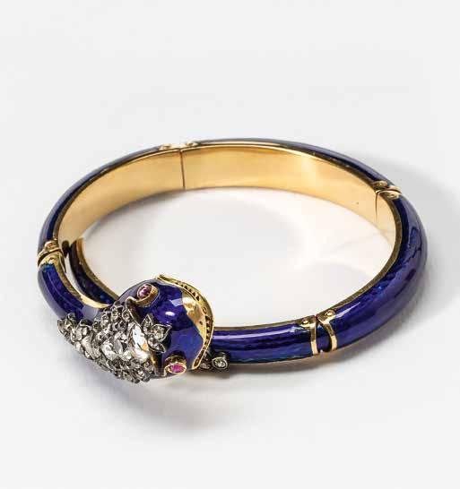 53 An 18 carat gold, diamond, ruby and blue enamel snake bracelet Circa 1890 The enamelled gold bracelet with four hinges, the head and tail rose-cut and old-cut