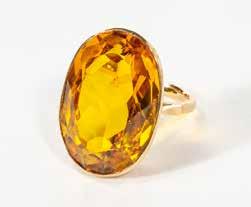 Ring size 54/17 1/4 Measured and weighed in the mount 700-900 86 A 14 carat gold and topaz ring Circa 1970 Set with an oval-cut gold topaz. Topaz spread approx. 23 x 16 mm Gross weight approx. 10 gr.