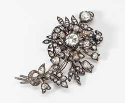 200 115 A 14 carat gold, silver and diamond flower brooch The Netherlands, circa 1900 Shaped as a spray of flowers, centered by a flower head throughout set with