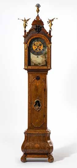 82 160 A Dutch burr-walnut longcase clock First half 18th century The hood with broken pediment and later turned finial, pierced architrave and sides, the glazed door flanked by two fluted pilasters,