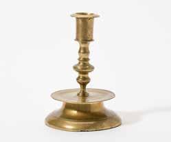 94 186 A French brass candlestick 16th century With a rimmed and pierced tapering socket, a knobbed and baluster shaped stem and