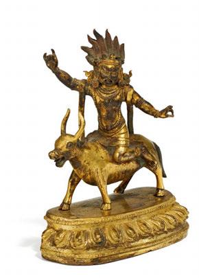 Sitting sideways on a lying down ox. The left arm streched out with the palm outwards, his right hand raised at chest level. He wears a girded garment around the hips as well as jewelry and a crown.