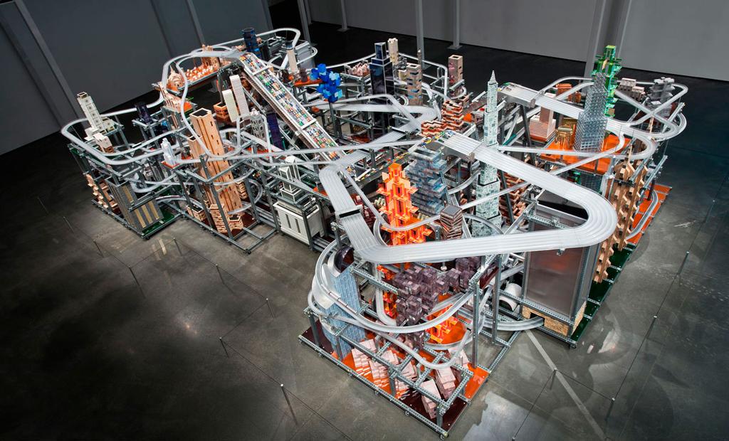 2010 Metropolis II is an intensely engineered kinetic sculpture with 1,100 miniature cars speeding through an elaborate system of roads, freeways, train tracks, and buildings at a speed of 240 scale