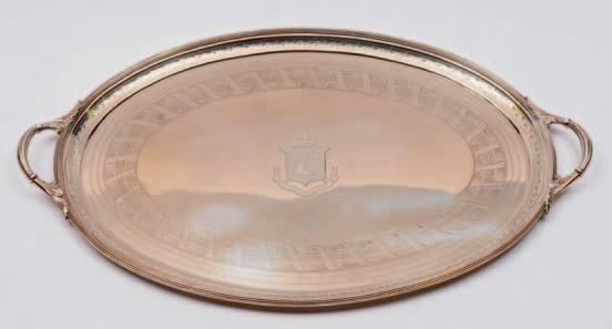 A Victorian oval twinhandled serving tray, crested, with reeded border, engraved foliate decoration, reeded and foliate loop carrying handles, 58cm.