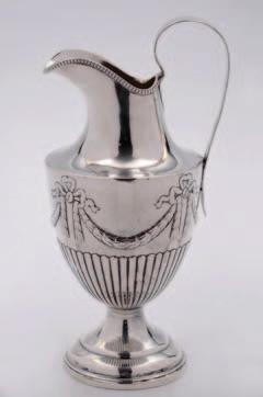 88 92 88. A George III baluster mug with leaf capped scroll handle on a spreading stepped foot, crested, London 1762, maker L B, probably Louis Black, 12cm high, 11 ozs. 89.