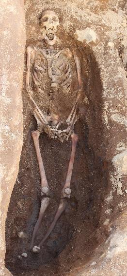 There were large stones at the top of the grave fill, marking the grave. It included the skeleton of an adult without a coffin.