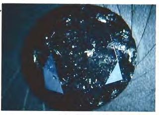 120) that the conductive property of such diamonds is due to the black inclusions, which are probably graphite. GRC Figure 3. The chrysoberyl from which this 31.