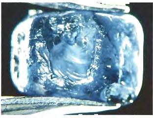 Figure 18. Immersion in methylene iodide revealed areas of diffusion treatment in this approximately 6.89 x 6.07 x 4.90 mm piece of sapphire rough from Montana.