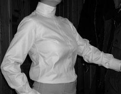 A long-sleeved shirt with white cuffs presents the most finished picture, however a short-sleeved shirt with a matching choker probably provides the most versatility as it can be worn with the jacket