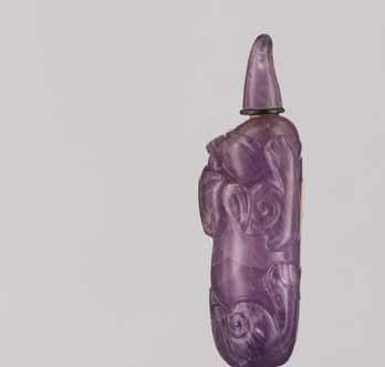 14 A CARVED AMETHYST AND BROWN CRYSTAL BUDDHIST LION SNUFF BOTTLE Crystal (amethyst and brown crystal) of intense purple color with a brownish tone and some dark-brown streaks at the lion s ball,