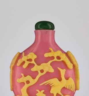 47 A YELLOW-OVERLAY PINK CRANES & PINES GLASS SNUFF BOTTLE Opaque pink glass with carved and incised lemon-yellow overlay, with some scattered minuscule air bubbles China, 1780-1860 The bottle is