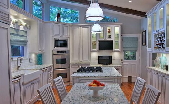 Creamy white cabinets are a perfect match for the bits of oyster shells nestled in the surface of the Floating Blue color mix.