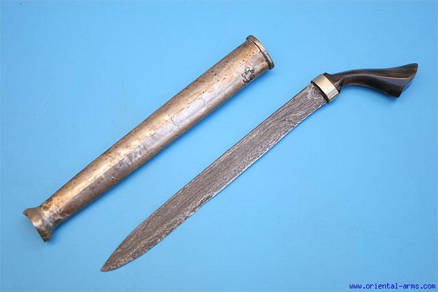 blade forged from fine twisted steel in the pattern known as Turkish Ribbon. It was mounted with a later, 19 C. Kilij shape 53 handle, with horn grips and silver grip strap and bolsters.