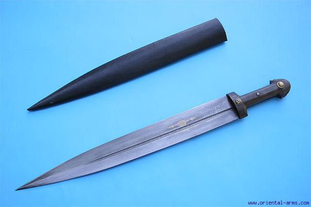 Daggers in this class may take various shapes. This one is probably late 17 to early 18 C., with heavy 9734 re-curving blade 10 ½ inches long with a central rib and shallow fullers.