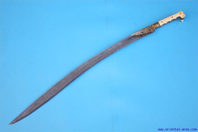 , sickle shaped. 11 inches (point to point) blade, 17 inches total length. The handle is ivory. Very good condition. Very good age patina on the handle.