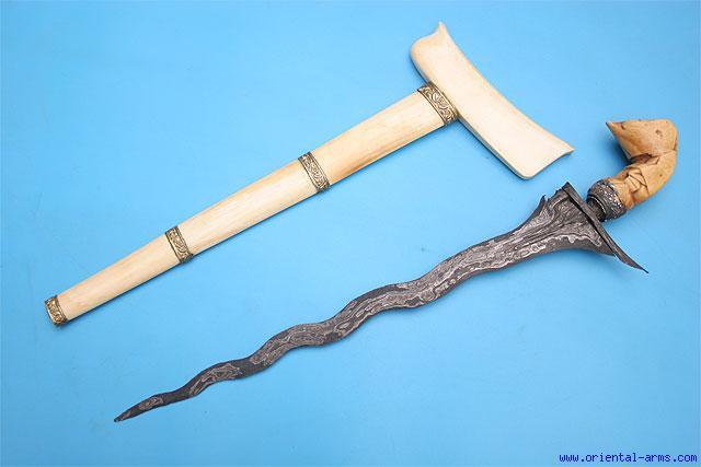 This keris dagger has a 14 inches waving blade forged from good pamor steel. The handle is Sumatra style made from ivory with good age patina 8777 and silver mendak (damaged and re glued).