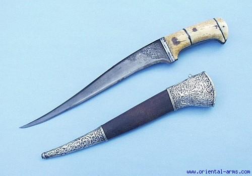 It is carried in attached to the rear side of the wide belt behind the Jambiya (Khanjar) dagger. It is found all over The Arabian peninsula id varying shapes.