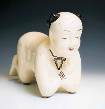 001 十九世纪磁州窑童子瓷枕 A Cizhou porcelain pillow, in form of kneeling boy, bent over and leaning on his elbows, the