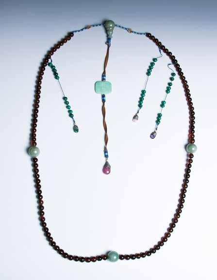 H: 8cm $8000-$10000 081 清琥珀翡翠朝珠一串 Consisting of a strand of 108 amber beads, divided into groups by the three mottled jadeite beads, the fotou at the back connected to a