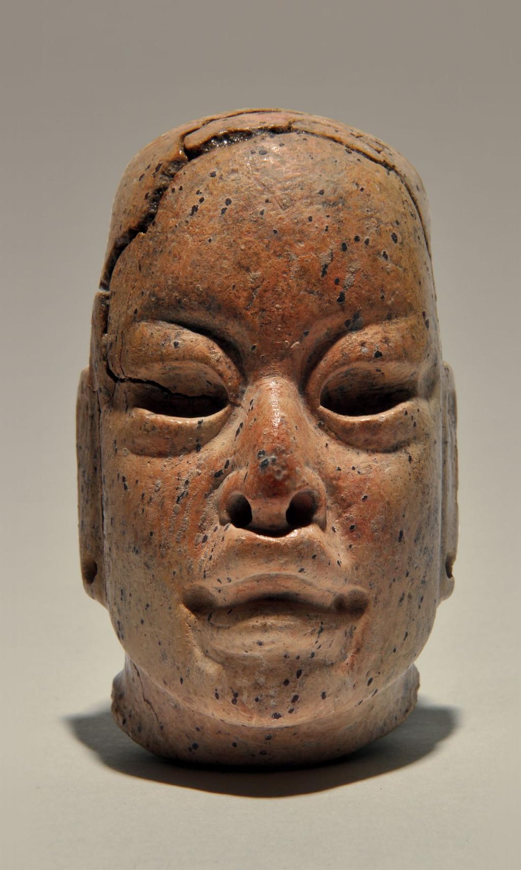 Figure 36. Olmec-style figurine head found in Cache 125. It measures 6.8 cm from the top of the head to the bottom of the chin. Cache 125. This cache was deposited during the Late Preclassic period, but the offering was most likely an heirloom dating back to the Middle Preclassic.