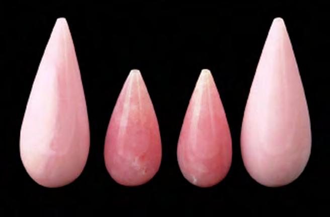 Figure 14. These four variegated pink drops, which range from 14.01 to 32.68 ct, were identified as pink opal. gray carving of a bird that was identified as opal by the West Coast laboratory.