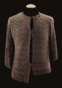 66 67 66 AN INDIAN MAIL SHIRT, 19TH CENTURY formed of small butted links arranged with layers of chevron pattern in copper, open at the front,