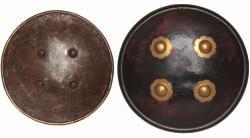 decorated with an applied crescent above four central bosses the first: 27cm; 10K in diameter (2) 300-400 72 AN INDIAN HIDE SHIELD, DHAL, AND ANOTHER, OF ETCHED STEEL, 19TH CENTURY 71 the first of