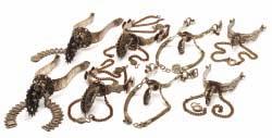 83 A LARGE MEXICAN ROWEL SPUR AND THREE FURTHER PAIRS OF MEXICAN ROWEL SPURS, 19TH CENTURY the first with U-shaped heel band, pierced slotted terminal for attaching straps, pierced filed neck