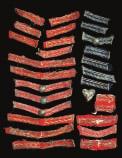 164 A BRITISH OFFICER S WAIST SASH, CIRCA 1790-1810 of crimson netted and tatted silk, fastened at the tassels (some moth and damage) The sash 54 inches in length (doubled), including tassels, almost