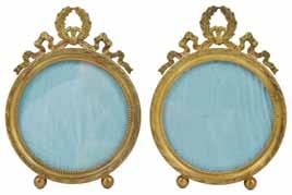 Oriental & Vertu 217. A pair of gilt metal Continental photo frames of circular form, raised on ball feet, with ribbon and wreath mounts, both with strut backs, height 13.5cm 40-50 218.