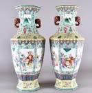 207. A pair of modern Chinese porcelain hexagonal vases, the bodies decorated with six panels, each with figures in a landscape holding flowers surrounded by floral ground