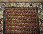 A Middle-Eastern style woolen rug, 16 medallions on red field, geometric border, 120 cm x 178 cm.