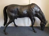 85. A contemporary bronzed garden sculpture of a horse lowering it s head to feed, 135 cm high x 194 cm wide 1500-2000 92.