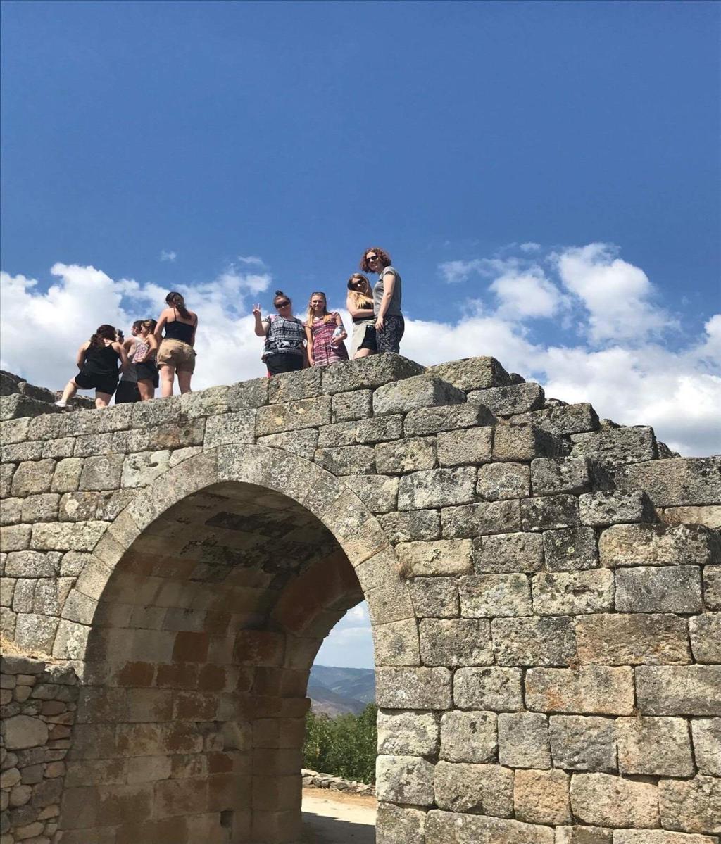 Photograph of Castelo de Numão with students hiking up the walls Photo description: On this particular outing it was a good idea to bring hiking shoes rather than sneakers.