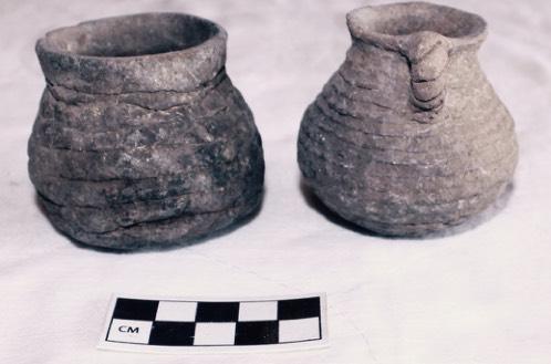 corrugated jars, a stone axe head, and a site