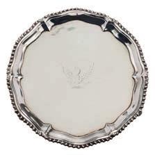 * 200-250 290 A George III silver waiter, maker Richard Rugg, London, 1765 crested, of circular form with gadrooned border, raised on three swept feet, 17.5cm. diameter, 8.98ozs.