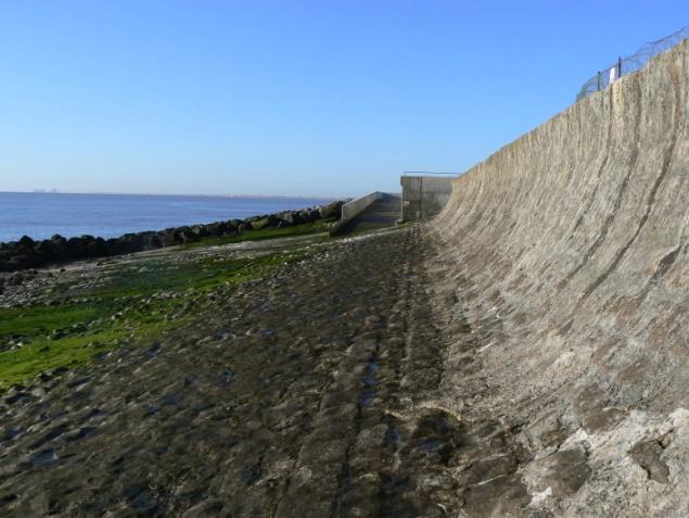 There is an easy clamber over a few rocks to a broad shingle track along the top of the sea defences.