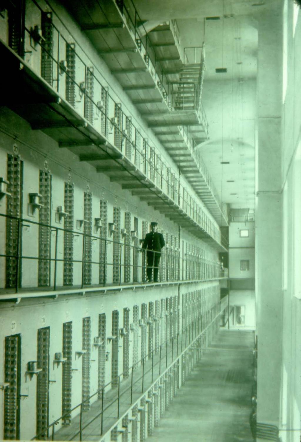 Since the cells were arranged back to back in tiers, there was no way for an inmate to tunnel through his cell wall to