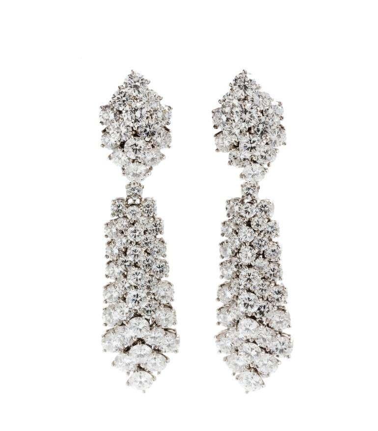 Sale 394 Lot 524 A Pair of Platinum and Diamond Convertible Day/Night Earclips, Van Cleef & Arpels, consisting of two hexagonal form clusters earclips supporting two detachable elongated chevron