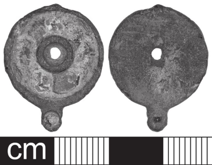 It was uncovered at Curry Rivel, in an area where other Roman finds have come to light. The flat circular lid measures 23.4mm by 18.4mm by 2mm and weighs 2.4g. A rounded lug projects from the edge.
