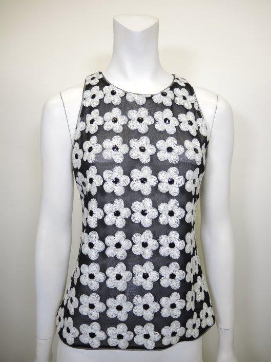 CHANEL Black and White Sequined Flower Tank Size 4 Sold in one day for $349. 05/12/18 Playful and feminine, this sleeveless blouse from Chanel epitomized summer in it s floral motif and sheer fabric.