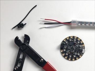 Start by connecting the in end of your first strip to the Circuit Playground.