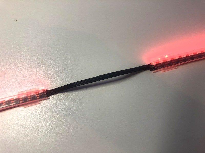 Time to test the strip! Plug a battery into your Circuit Playground and be sure both strips light up. If everything is working, it's time to secure the end of the strips.