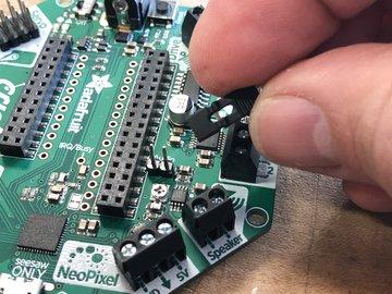 There is a tiny trim potentiometer on the Crickit just below the