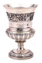 54. A George IV goblet, of campana form, half fluted with a band of chased fruiting vine on a matt ground, on a raised circular foot, London 1825,