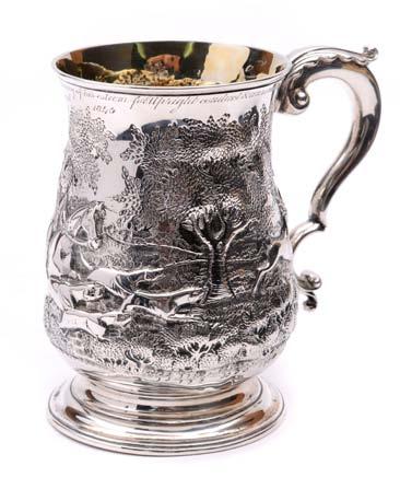 A George III baluster mug with scroll handle, later embossed with a stag hunting scene and engraved presentation inscription beneath the upper rim,
