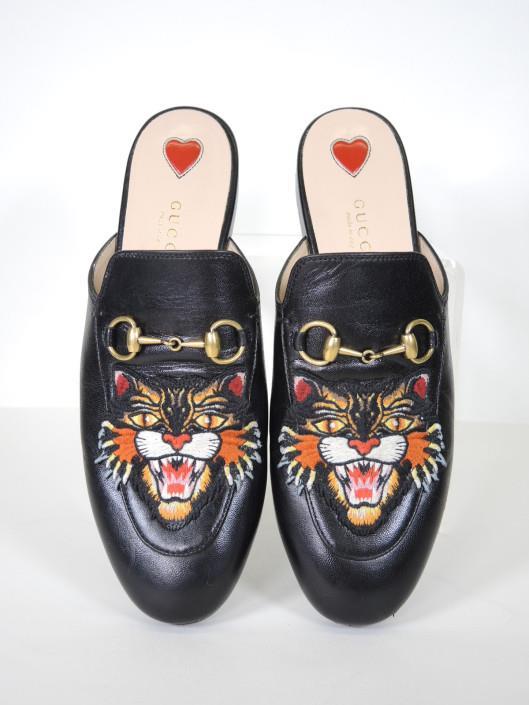 GUCCI Black Leather Kings Tiger Slides, Size 6.5 Retailed for $820, sold in one day for $299. 01/26/19 Fierce and playful, these black leather slides are a great take on a classic style.