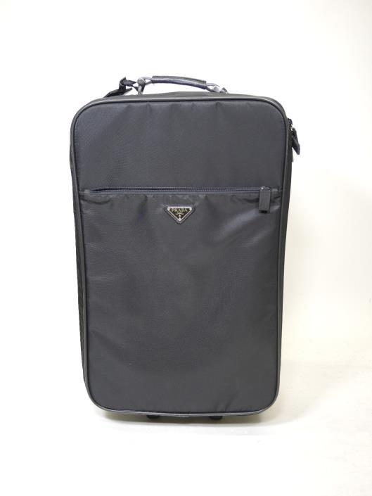 Prada Black Roller Luggage Retailed for $2500, sold in one day for $699. 01/19/19 Jet set in style with this sleek all black luggage crafted out of Prada s Vela nylon with leather trim.