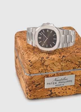 - The auction - lot 62. lot 130. PATEK PHILIPPE An extremely rare and very attractive stainless-steel automatic wristwatch with tropical dial, date, bracelet and Nautilus cork box.